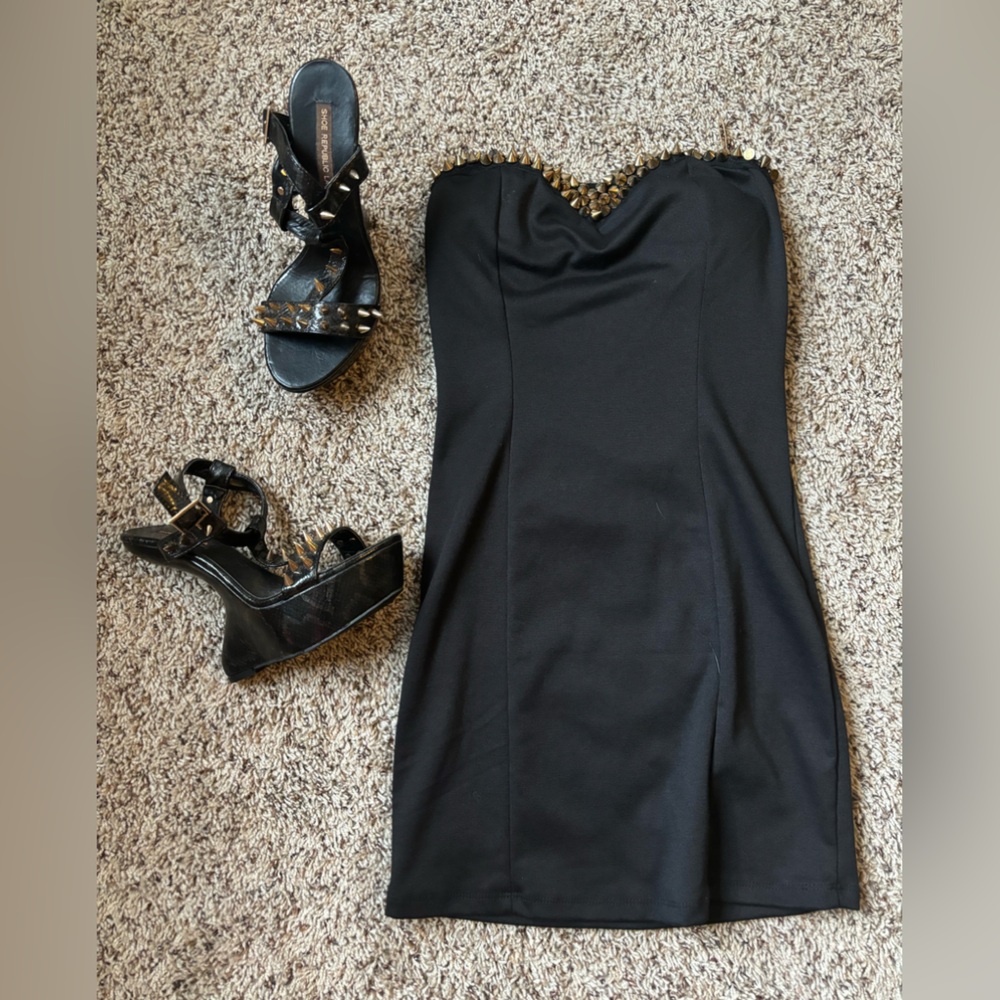 Black small dress with gold spikes, matching heel-less heels with gold spikes